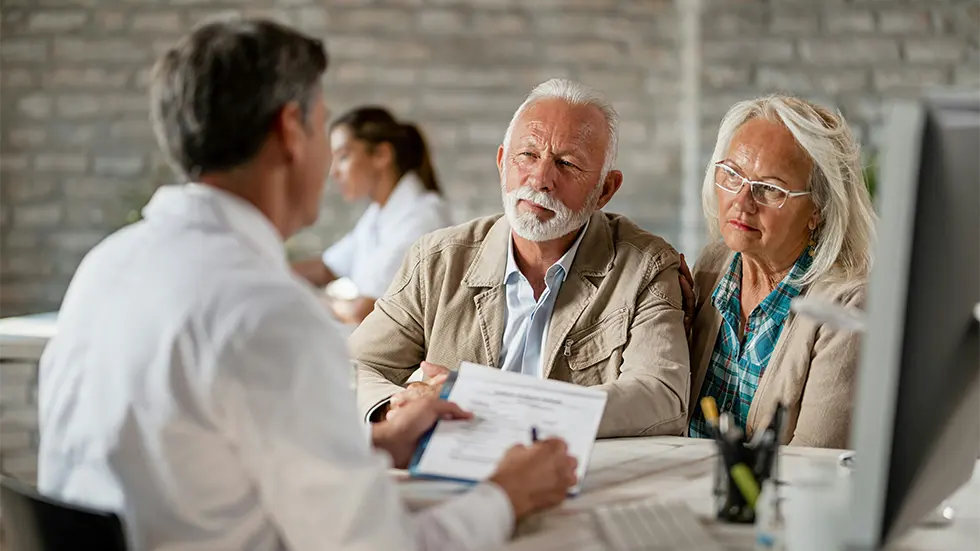 financial-planning-services elderly couple talking to an advisor